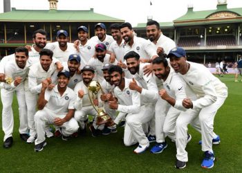 The Indian team poses for a photograph with the Border-Gavaskar Trophy as they celebrate a 2-1 series victory over Australia following play being abandoned in the fourth test match between Australia and India at the SCG in Sydney