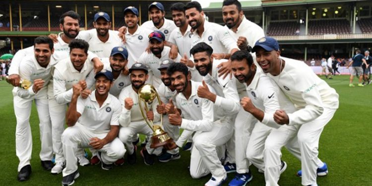 The Indian team poses for a photograph with the Border-Gavaskar Trophy as they celebrate a 2-1 series victory over Australia following play being abandoned in the fourth test match between Australia and India at the SCG in Sydney